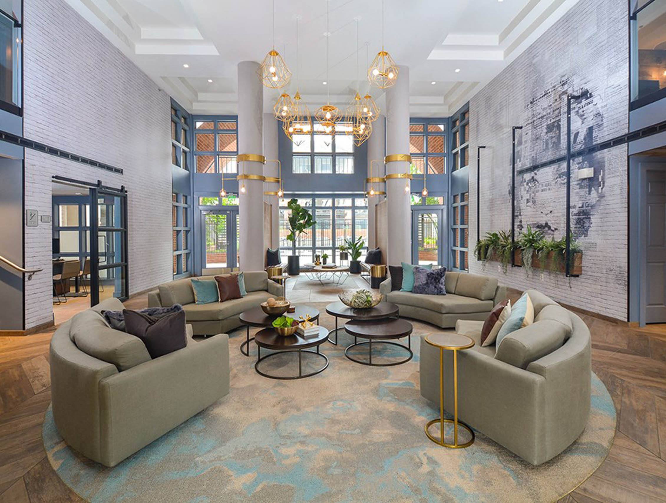 a living room with couches and chairs and a large window at The Citizen at Shirlington Village, Virginia, 22206